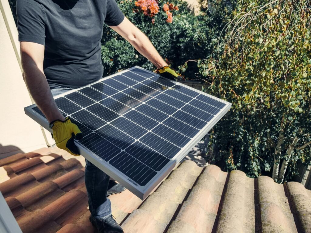 Engineers installing rooftop solar panels under clear skies